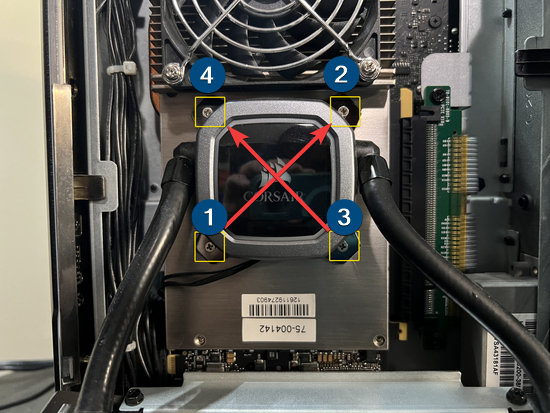 CPU cooler installation with labeled screws.
