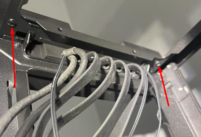 Wires and screws inside a device frame.