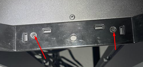 Ports and screws on a metallic surface.