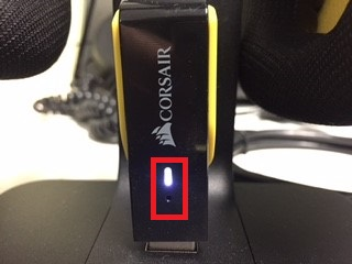Corsair headset with illuminated indicator light.